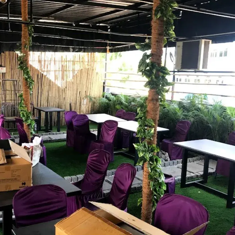 Rooftop garden seating at AHMEDIA Hotel, Vaniyambadi